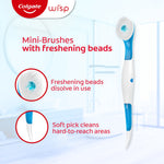 Full Colgate Wisp disposable mini-brush displayed upright with callouts showing freshening beads and a soft pick feature on a light background.