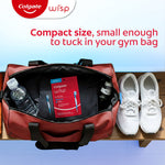 Open gym bag with a red Colgate Wisp pouch inside next to a water bottle and pair of white sneakers, caption about compact size.