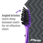 Close-up of purple Colgate ZigZag toothbrush head showing angled charcoal bristles and arrow pointing to bristle design