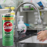 Comet powder can placed by a kitchen sink faucet with running water and blurred sink items in background.