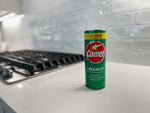Comet bleach powder can standing on a kitchen counter near a stovetop with tiled backsplash in soft focus.
