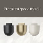 Three Command Décor metal wall planters in black, brass and off-white under headline ‘Premium grade metal’