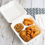 Open compostable 3-compartment container filled with fried chicken, fries and rice beside disposable utensils