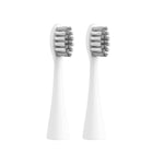 Two white ConairClean sonic toothbrush replacement heads photographed on a clean white background.