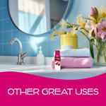 California Scents Coronado Cherry aerosol spray shown on a bathroom counter with folded towels and flowers behind it