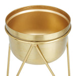 Close-up of the interior and rim of a gold metal planter bowl sitting in its hairpin stand
