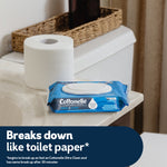 Blue Cottonelle Fresh Care wipes pack on a bathroom counter next to a toilet paper roll with 'Breaks down like toilet paper' text