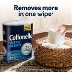 Lifestyle scene showing Cottonelle Ultra Clean packaged rolls next to a basket of stacked toilet paper squares and a hand picking one