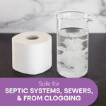 Toilet paper roll beside a beaker of water showing dissolving fibers with purple label claiming safe for septic systems