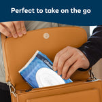 Compact Cottonelle Ultra Fresh flip-top pack being placed into a purse with product tagline
