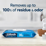 Cottonelle XL flushable wipes pack on a bathroom counter with text claiming removal of residue and a blurred towel arrangement in background.