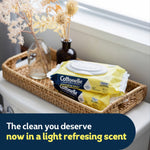 Two Cottonelle Summer Fresh flushable wipes packs staged in a woven tray with dried flowers