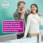 Two people smiling and brushing teeth at a bathroom sink with Tom’s toothpaste visible and a product benefits panel