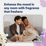 Smiling couple on couch with surrounding lavender and vanilla floral graphics promoting room fragrance
