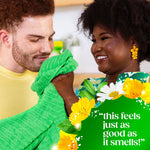 Two people smiling as one inhales a bright green towel, foreground floral graphics and quote 'this feels just as good as it smells!','filename':'couple-enjoying-gain-scented-towel' 