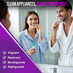 Lifestyle image of a man and woman in a bathroom mirror, each holding clear aligners while a GuruNanda foam bottle appears in the foreground.