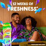 Relaxed couple laughing on a couch with a Gain +odor defense bottle and text '12 weeks of freshness' overlay
