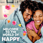 Smiling couple wrapped in a blanket with floral graphics and text 'Welcome to the world of Happy' promoting Gain Happy scent