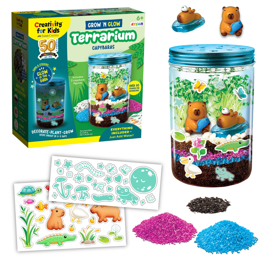 Creativity for Kids terrarium kit box and assembled jar with capybara figurines, stickers, colored sand and potting mix.