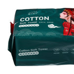 Cropped view of a green cotton soft towel package showing branding, product name and wave motif on glossy packaging