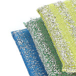 Tightly cropped view of blue, green and yellow metallic scrub pads layered together