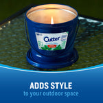 Cutter blue outdoor candle bucket burning on a glass tabletop with caption 'adds style to your outdoor space'