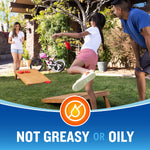 Outdoor lifestyle scene of family playing cornhole in a yard with "Not greasy or oily" banner and Cutter icon