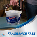 Lifestyle photo of a person carrying a DampRid bucket by its handle on a tabletop with “Fragrance Free” text band
