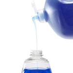 Blue dish soap being poured from a Dawn bottle into a refill container, close-up of flow