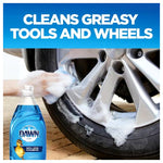 Person wiping a soapy car wheel with a sponge and a Dawn Ultra bottle graphic at the lower left with headline about cleaning greasy tools.