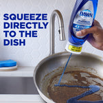 Hand squeezing an upside-down Dawn Platinum EZ-Squeeze bottle dispensing blue liquid into a dirty pan with text 'Squeeze directly to the dish'