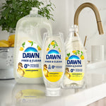 Lifestyle product group showing three Dawn Free & Clear Lemon Essence refill and pump bottles on a kitchen counter