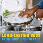 Hand scrubbing a stainless frying pan under running water with lots of suds and text about long-lasting suds