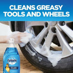Close-up of a person cleaning a car wheel with suds and a small Dawn Ultra bottle graphic plus headline about cleaning greasy tools.