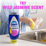 Dawn Platinum wild jasmine bottle on a counter with someone washing a glass in a kitchen sink and 'try wild jasmine scent' text