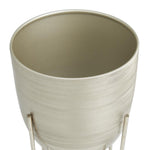 Top-down closeup of a brushed silver metal planter showing textured interior rim and finish