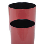 Close-up of two nested red metal planters showing glossy exterior and black interior rims against white background