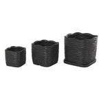 Three black wavy-ribbed ceramic planters arranged in a row on a white background