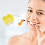 Lifestyle image of a white and yellow denture storage case and orange denture brush beside a smiling person holding a dental appliance