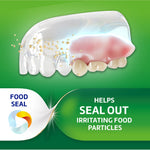 Illustration of a denture showing particles being kept out and a green panel reading ‘HELPS SEAL OUT IRRITATING FOOD PARTICLES’