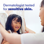 Parent wrapping a small smiling child in a towel with text 'Dermatologist tested for sensitive skin' and Tide branding