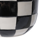 Tight crop showing the glossy black-and-white checkerboard pattern on a ceramic planter surface.