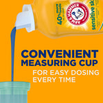 Close-up of detergent bottle pouring blue liquid into a measuring cup above text about convenient measuring cup