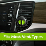 Black and green round vent diffuser clipped to a car air vent shown in a vehicle dashboard with text saying fits most vent types