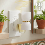 Lifestyle image of a plug-in diffuser in a bathroom setting releasing vapor with the BHG monogram visible