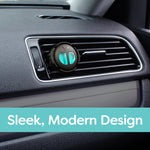 Close-up of a black and teal Refresh Your Car vent diffuser installed in a horizontal car vent grille