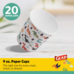 Single dinosaur-print paper cup angled on a light wood surface with Glad branding and '20 paper cups' badge