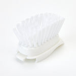 White Dish Daddy scrub brush head standing on its side showing dense vertical nylon bristles and curved plastic base.