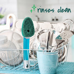 Dishwand with green scrub head standing in a dish rack surrounded by clean dishes with text reading rinses clean