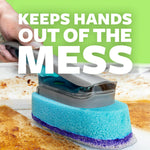 Close-up of a hand using a dishwand scrubber on a baked-on mess with bold text 'KEEPS HANDS OUT OF THE MESS'